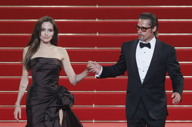 Image: Cast member Pitt and actress Jolie leave the festival palace after the screening of the film \"The Tree of Life\" in competition at the 64th Cannes Film Festival
